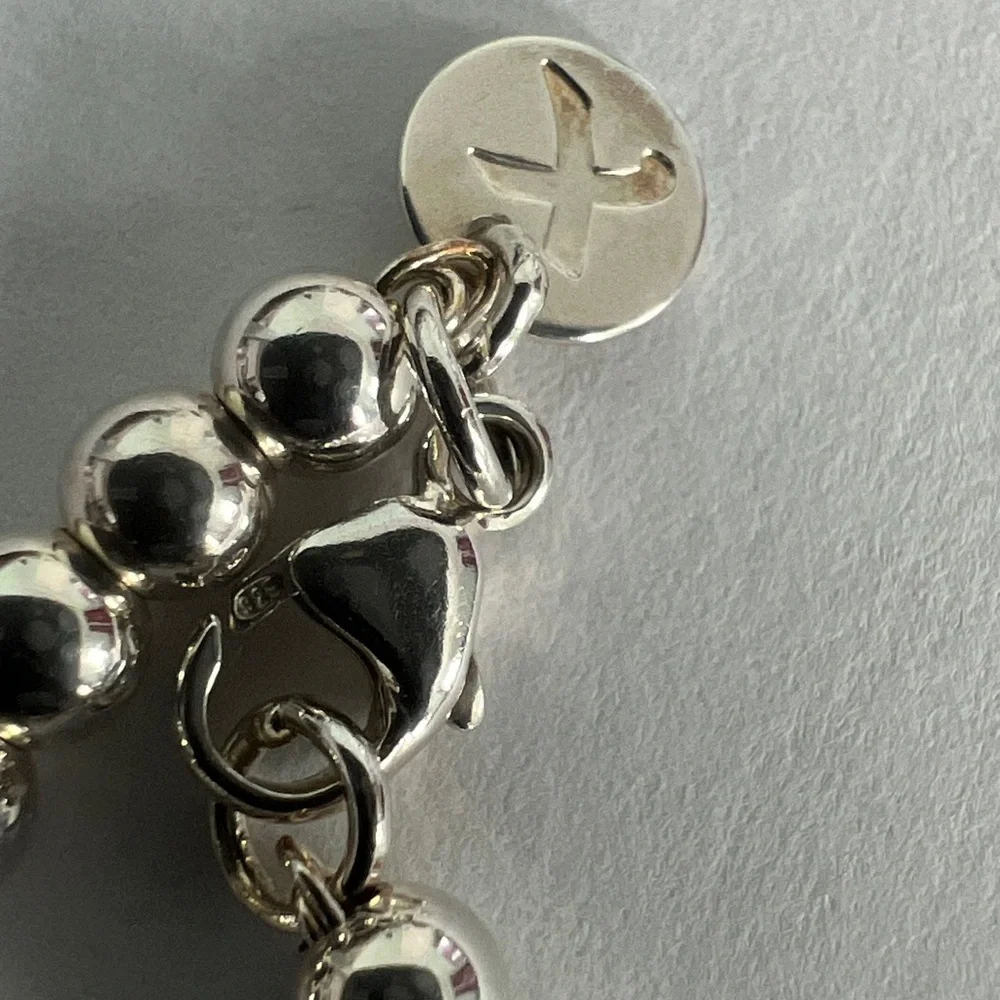 Elegant Silver Beaded Bracelet with Blue Charm